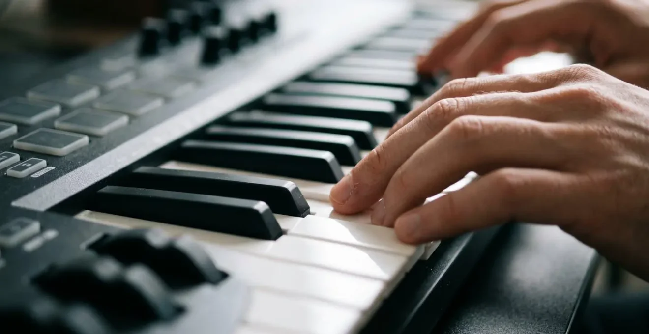 A dynamic, hands-only shot of a producer making quick, confident decisions at a MIDI controller with purposeful movement.