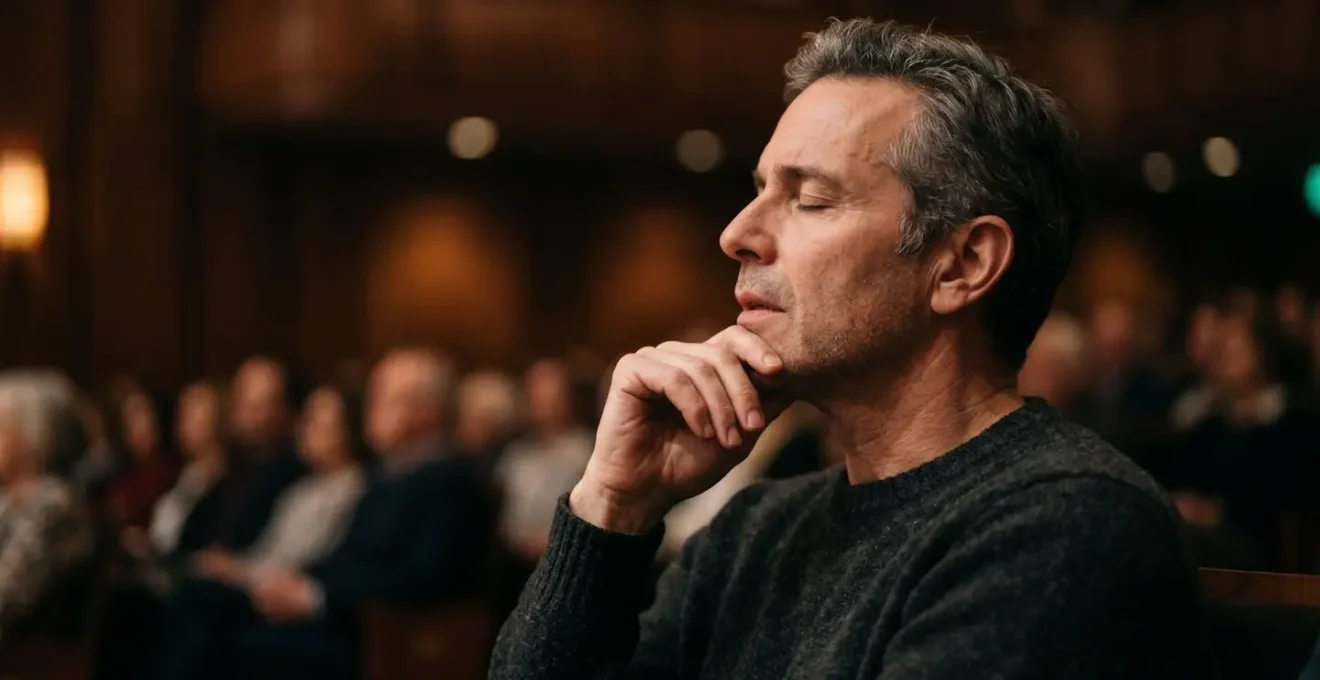 Close portrait of a person deeply engaged in listening to orchestral music, showing authentic emotional connection