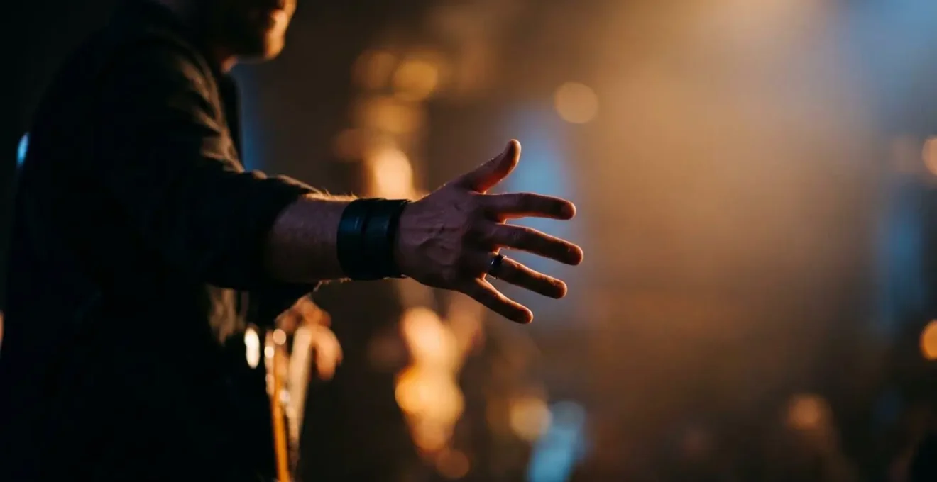 Symbolic visual metaphor showing the intangible connection between performer and audience through light and gesture