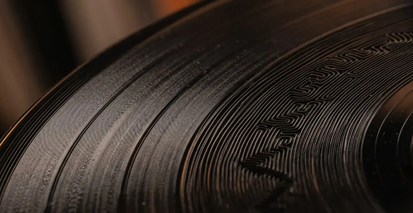 Macro detail of vinyl record grooves transitioning from smooth to complex textural patterns