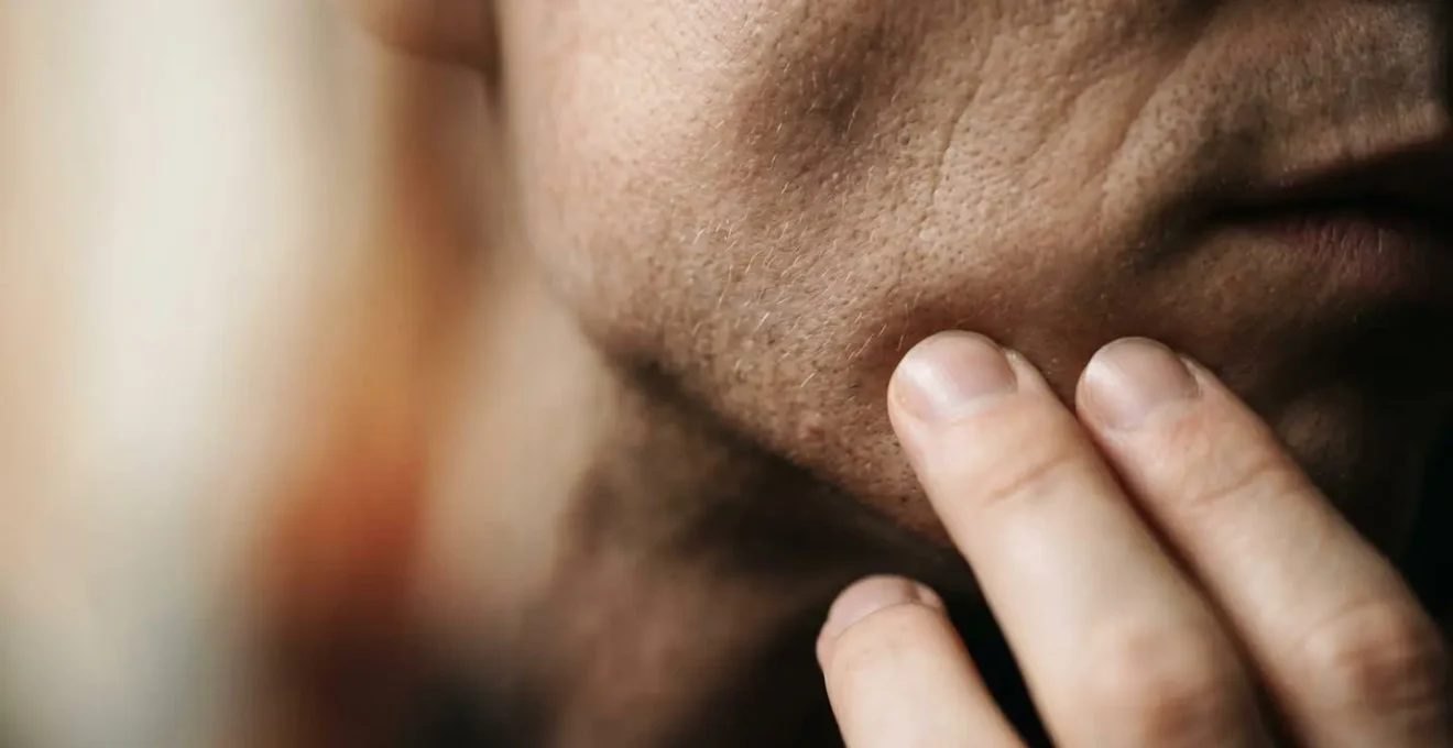 Close-up macro detail showing facial muscle tension and jaw alignment in brass instrument performance